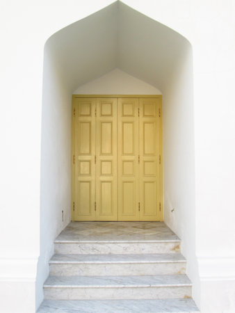 Entrance is yellow door and a marble staircase in the ancient temple of Thailandの写真素材
