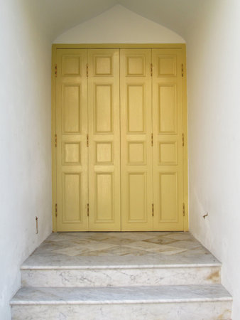 Entrance is yellow door and a marble staircase in the ancient temple of Thailandの写真素材