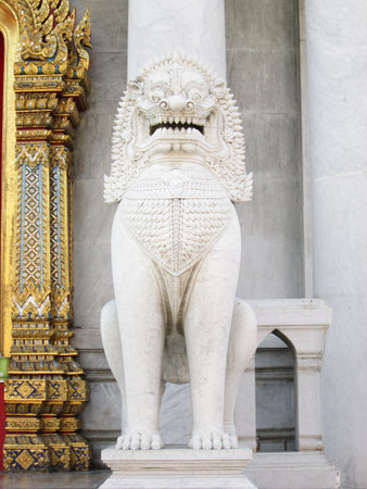 BANGKOK, THAILAND - APRIL 22 :The over 150 years ancient marble lion standing at front of main temple at Benjamaborphit temple,Bangkok, Thailand.April 22, 2014.のeditorial素材