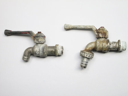 old faucet isolated on a white backgroundの写真素材