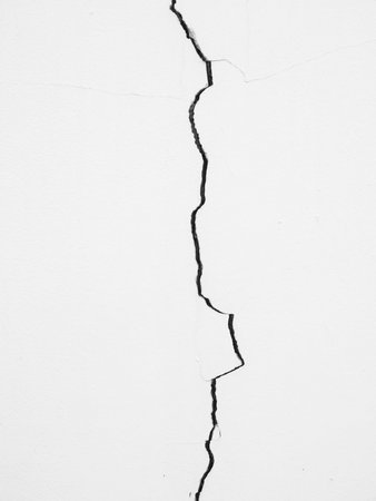 Cracked concrete wall a long wayの写真素材