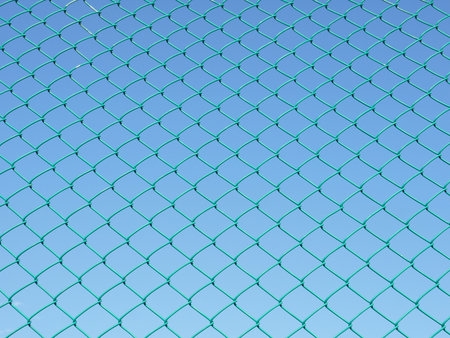 Green seamless fence chain, Iron wire fence on blue sky background