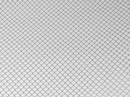 Steel mesh with a gray sky backgroundの写真素材