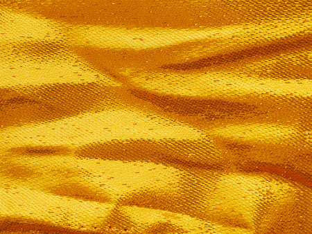 golden crumpled fabric textureの写真素材