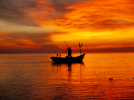 sunrise silhouette people are fishingの写真素材