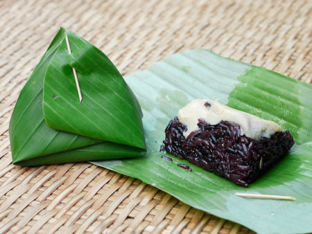 Thailand dessert rice Steamed custard wrapped in banana leaves on basketの写真素材