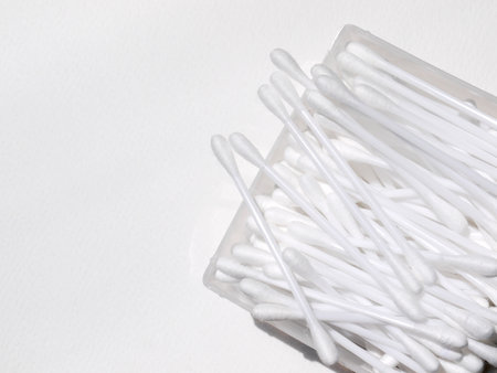 Cotton sticks on the white paper backgroundの写真素材