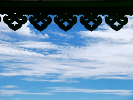 silhouette of Thai roof edge in blue sky