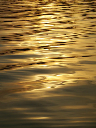 Abstract golden reflection on waterの写真素材