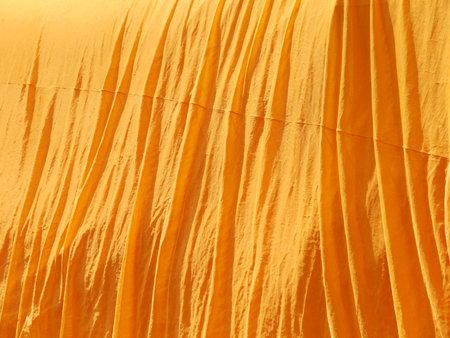 crumpled yellow monk robe. Backgroundの写真素材