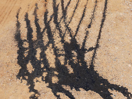 Oil slick on the red roadの写真素材
