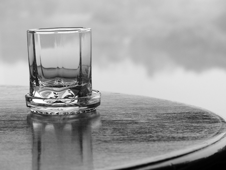 black and white glass on wood tableの写真素材