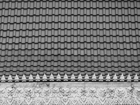 Thai temple roof with thai angels relief detail on ceramic roofの写真素材