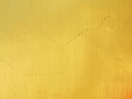 golden wall with crack textureの写真素材