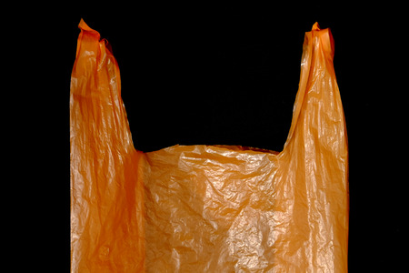 orange plastic bag on black backgroundの写真素材