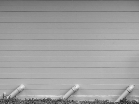 Drain pipes against gray wallの写真素材