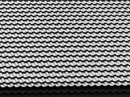black and white tile roof with light and shadow patternの写真素材