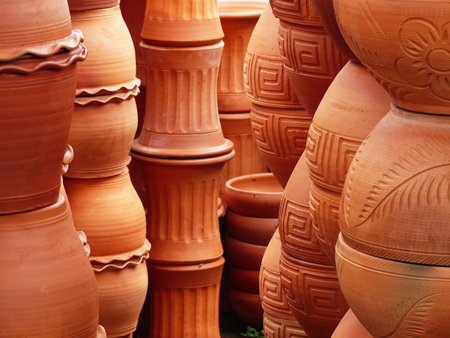 Piles of terracotta pots in a storeの写真素材