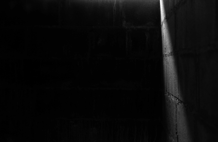 light and shadow on cement block wall black and white toneの写真素材