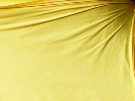 Yellow fabric cloth texture backgroundの写真素材