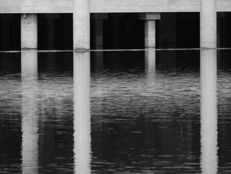 Pole building with water reflection waveの写真素材