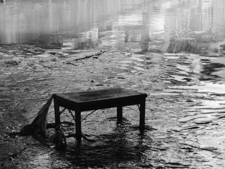Old wooden tables on the waterの写真素材
