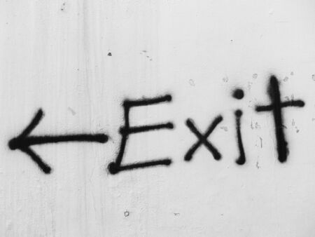 painted exit sign on white wallの写真素材