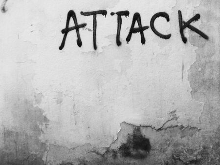 painted attack on old white wallの写真素材