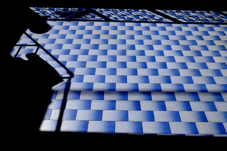 shadow on blue tile floor in the homeの写真素材