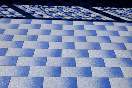 shadow on blue tile floor in the homeの写真素材