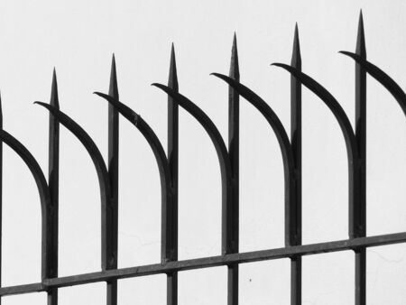 Old fashioned spike fence on white backgroundの写真素材