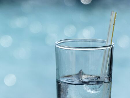 closeup glass of iced water with strawの写真素材