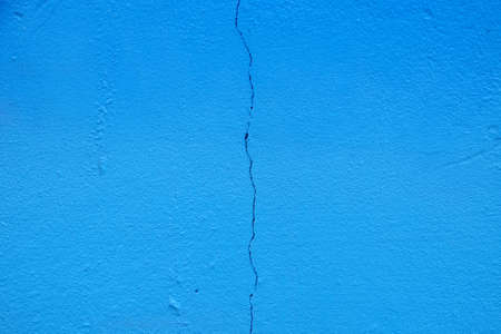 blue paint wall background with crackの写真素材
