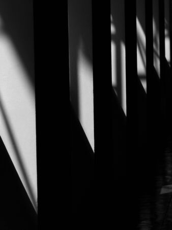 black and white light and shadow on wall in the roomの写真素材