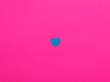 Blue heart on pink paperの写真素材