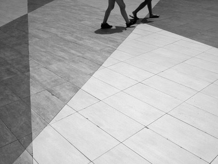 black and white people walk on street floorの写真素材
