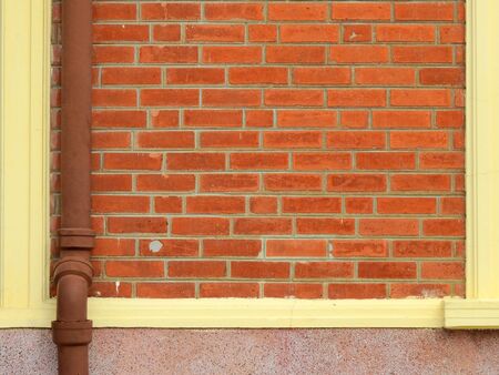 old brick wall with pipe tube