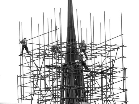 Workers on the scaffolding are building a pagoda black and white styleの写真素材