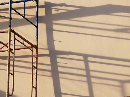shadow on wall with scaffoldingの写真素材