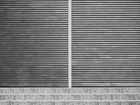 corrugated metal sheet slide door and roller shutter with staircaseの写真素材