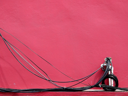wire cable on red brow wall background