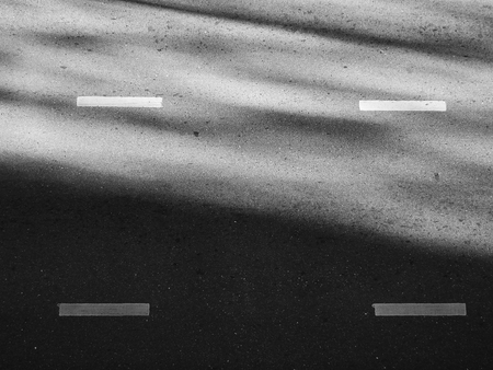 light and shadow on asphalt road black and white styleの写真素材
