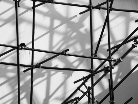 scaffolding with shadow on wall in construction siteの写真素材