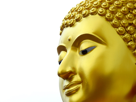 gold buddha face closeup on white backgroundの写真素材