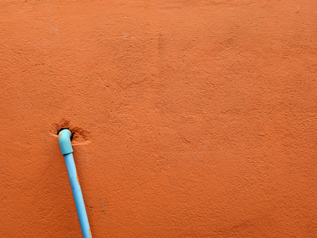 blue water pipe on brown wall background