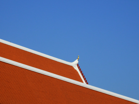 temple roof of Thailand with blue sky backgroundの写真素材
