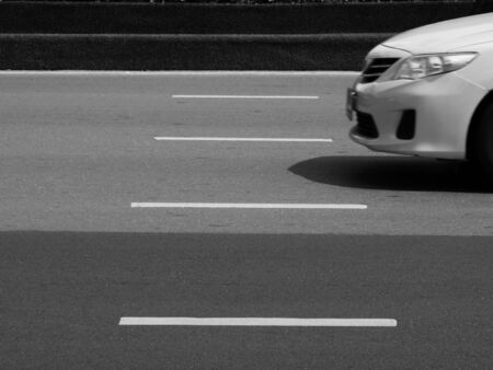 car is running on the road in city, black and white styleの写真素材