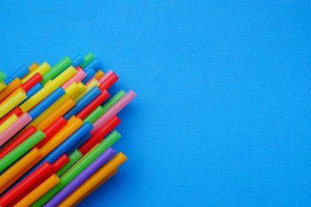 colorful of straw on blue paper with space background