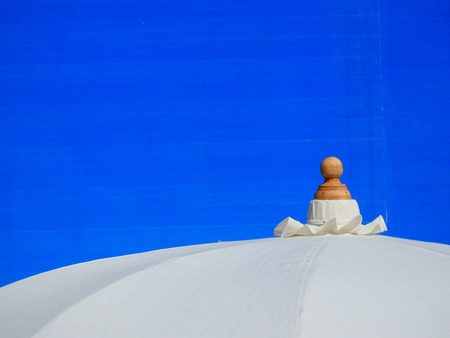 White umbrella with blue backgroundの写真素材