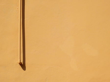 pipe with shadow on brown wall background, minimalism styleの写真素材